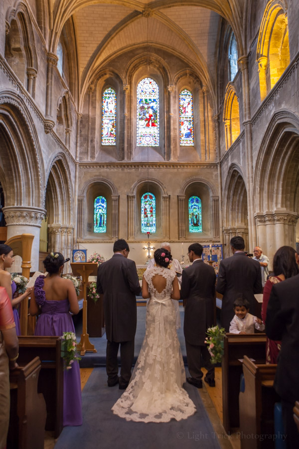 bride and groom at the front of church aisle
